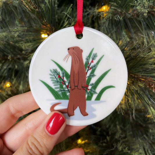 Singapore Christmas Ornament, Otter holding a twig of holly